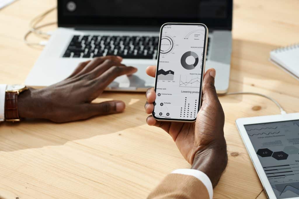 a man working with crm mobile app with his laptop